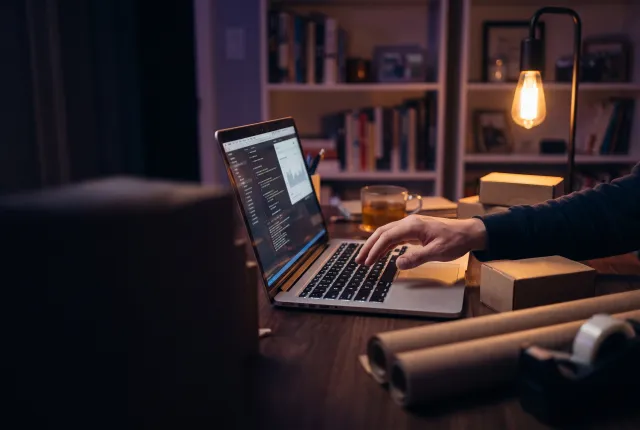 Etsy Product Engine — a home studio at night, laptop glowing, a hand lifting off the keyboard