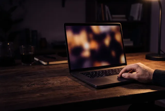 The Website Factory — eight devices on a dark surface, each screen glowing with a different layout